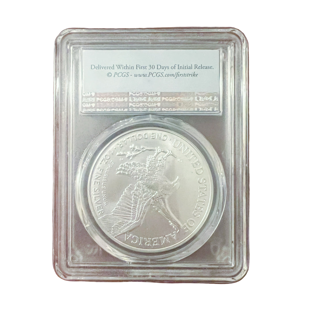 Silver coin in a protective case on a wooden surface